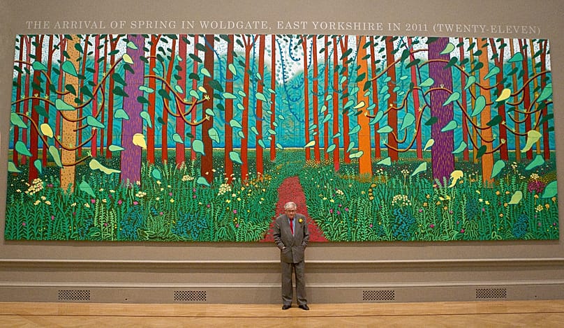 British artist David Hockney stands before one of his paintings of the East Yorkshire landscape at The Royal Academy of Arts in Piccadilly, London, 16 January 2012.