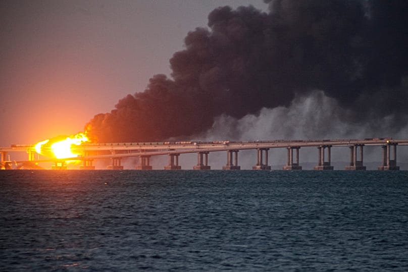 FILE - Flame and smoke rise from Crimean Bridge connecting Russian mainland and Crimean peninsula over the Kerch Strait, in Kerch, Crimea, on Oct. 8, 2022.