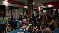 Soccer fans watch a broadcast of the opening match of the World Cup soccer tournament between Mexico and South Africe at a local coffeeshop in Gaza Strip