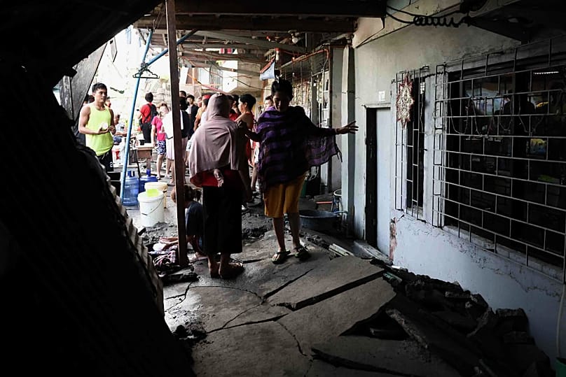 Residents walk along a damaged pathway in General Santos, 11 June, 2026