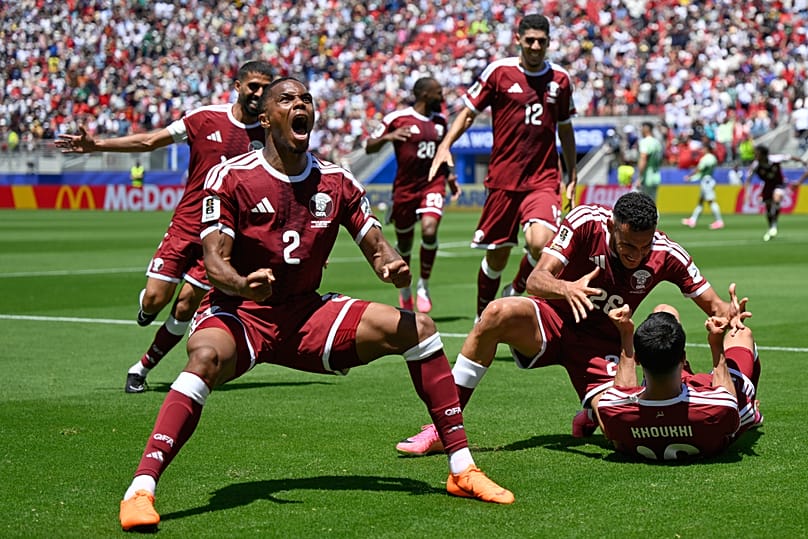 Qatar's Pedro Miguel celebrates teammate Boualem Khoukhi's goal during the World Cup football.match between Qatar and Switzerland