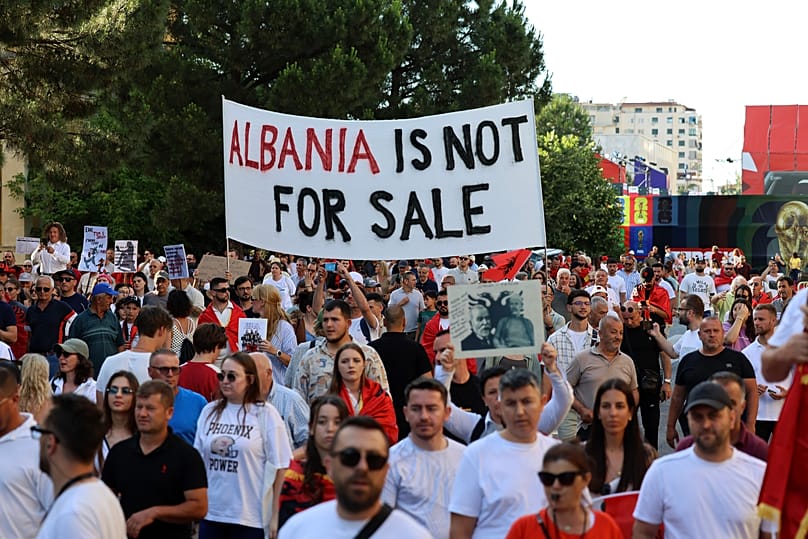 Manifestanti partecipano a una manifestazione a Tirana, 13 giugno 2026