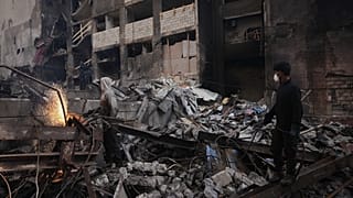 عامل يقطع خردة معدنية بينما تتطاير الشرر وسط الحطام في موقع مبنى دمر في غارة جوية إسرائيلية الأربعاء الماضي في وسط بيروت،
