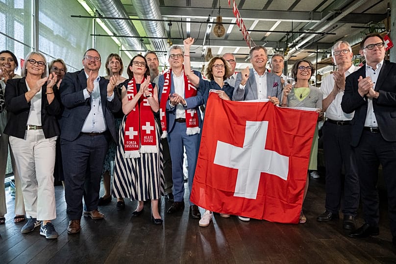 Members of the Federal Parliament and other representatives of civic organizations, celebrate during a get-together of a cross-party alliance against SVP's popular initiative.
