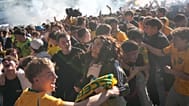 Fans celebrate in Sydney, Sunday, June 14, 2026, after an Australian goal against Turkey in their World Cup Group D soccer match. (AP Photo/Rick Rycroft)