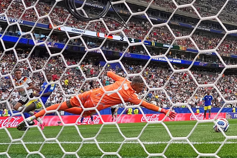 Curaçao goalkeeper Eloy Room beaten by a shot from Germany's Jamal Musiala to score their fourth goal during the World Cup Group E match in Houston, Sunday, June 14, 2026