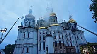 Rescue workers tries to put out a fire at the Kyiv-Pechersk Lavra, also known as the Monastery of the Caves, following a Russian strike in Kyiv, Ukraine, Monday, June 15, 2026