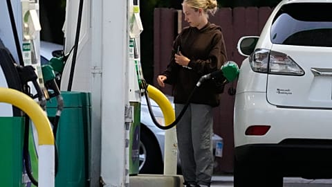 Customer checks gas price before she fills up her vehicle's tank at a gas station in Lincolnshire, Ill., Monday, June 8, 2026. (AP Photo/Nam Y. Huh)