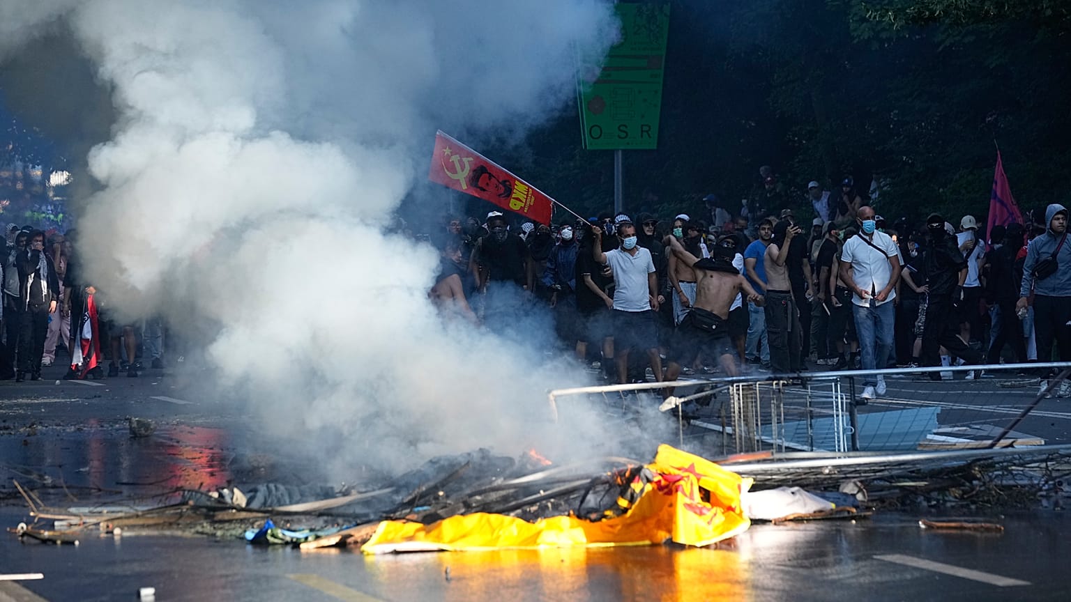 A protester throws an object during a "No G7" demonstration in Geneva