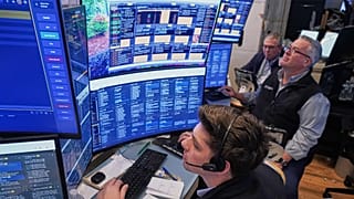 A trio of traders work on the floor of the New York Stock Exchange, 3 June 2026