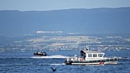 A France's National Gendarmerie boat patrols on Lake Geneva ahead of the G7 summit in Evian-les-Bains, France, Monday, June 15, 2026. (AP Photo/Christophe Ena)