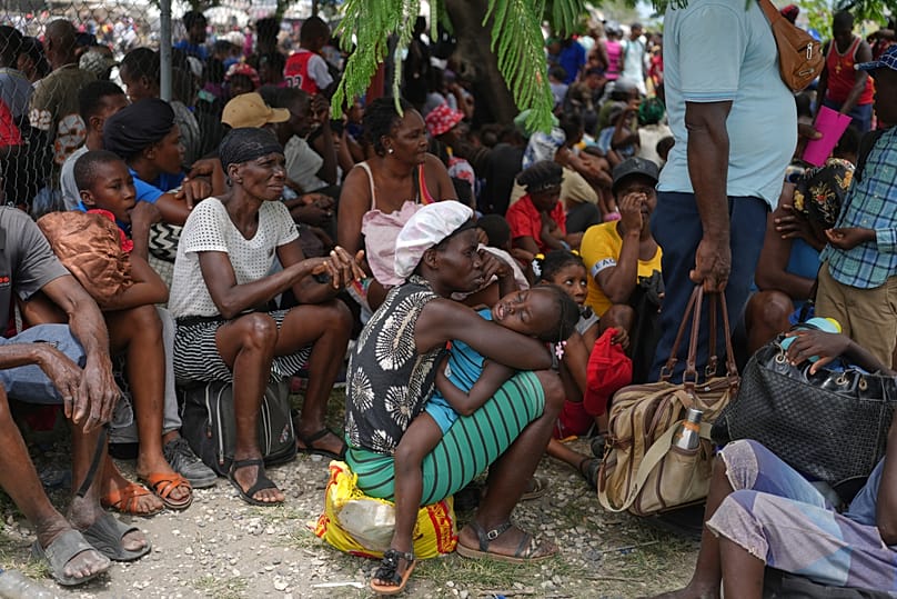 People displaced from their homes due to clashes between armed gangs take refuge at a police station in Port-au-Prince, 11 May, 2026