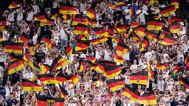 Germany fans wave flags on the stands before the start of the World Cup Group E match between Germany and Curacao in Houston, Sunday, June 14, 2026.