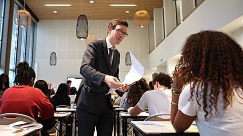 France's Education Minister Edouard Geffray, centre, delivers to students their maths exam paper at the Gabriel Faure school and middle school in Paris, 12 June 2026. 