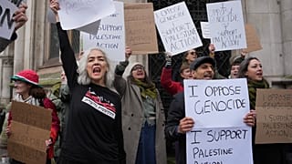 Supporters of Palestine Action stage a protest outside the Royal Court of Justice in London, Friday, Feb. 13, 2026.