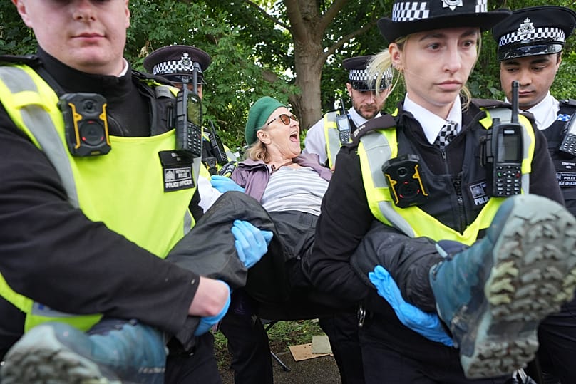 Protesters are detained by police outside Woolwich Crown Court, London, during a hearing where Palestine Action activists are sentenced, June 12, 2026.