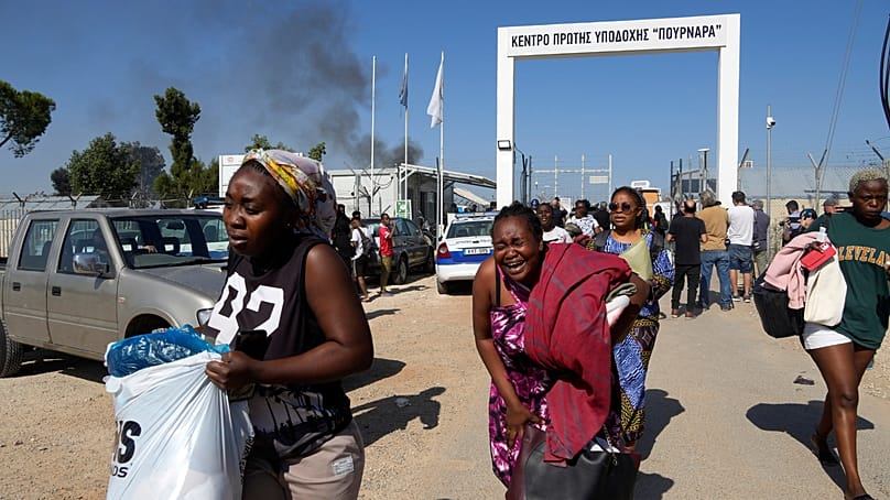 Female migrants exit the Pournara migrant reception center. Oct. 28, 2022. (AP Photo/Petros Karadjias, File)