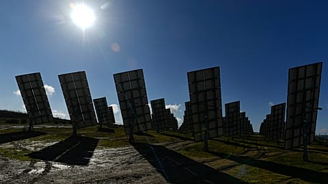 Solar panels work in Los Arcos, Navarra Province, northern Spain, Friday, Feb. 24, 2023