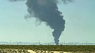 Smoke plumes rise from a B-52 bomber that crashed shortly after takeoff at a U.S. Air Force base in Southern California,