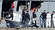 Migrants disembark from the Italian navy ship Libra at the port of Shengjin, where Italy set up a center similar to a return hub
