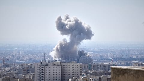 A plume of smoke rises after a strike in Tehran, 1 March 2026