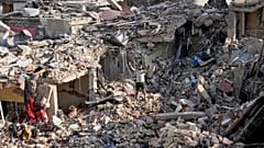 A man flashes peace sign as he stands on the rubble of his destroyed house in Nabatiyeh town, southern Lebanon, Tuesday, June 16, 2026.