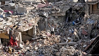 A man flashes peace sign as he stands on the rubble of his destroyed house in Nabatiyeh town, southern Lebanon, Tuesday, June 16, 2026.