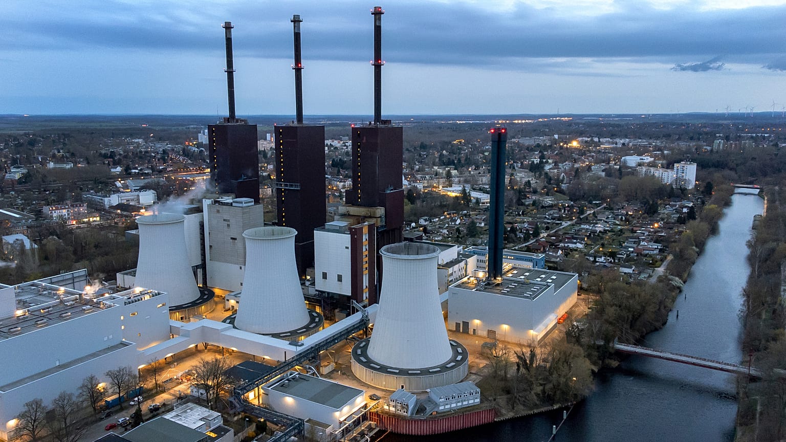 FILE - Steam leaves a cooling tower of the Lichterfelde gas-fired power plant near a cable bridge crossing the Teltow canal in Berlin, Germany, on March 30, 2022.