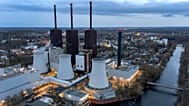 FILE - Steam leaves a cooling tower of the Lichterfelde gas-fired power plant near a cable bridge crossing the Teltow canal in Berlin, Germany, on March 30, 2022.