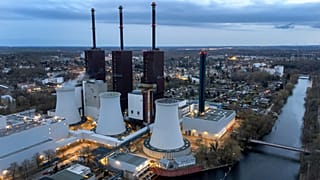 FILE - Steam leaves a cooling tower of the Lichterfelde gas-fired power plant near a cable bridge crossing the Teltow canal in Berlin, Germany, on March 30, 2022.