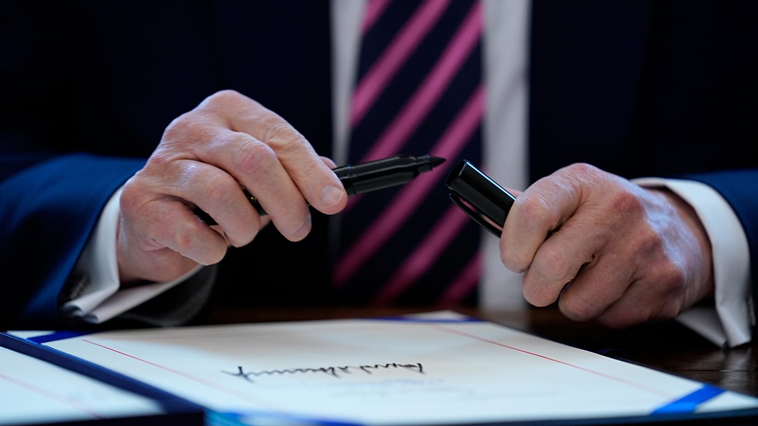 FILE: US President Donald Trump puts the cap on a pen after signing a directive at the Oval Office of the White House, 24 April 2020