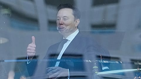 Elon Musk gestures as he walks through a hallway inside the US District Court in Oakland, 29 April, 2026