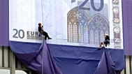 Mountaineers abseil from the European Central Bank highrise building to unveil huge replicas of the new euro banknotes, following the official presentation of the new currency