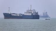 A small motorboat passes anchored vessels in the Strait of Hormuz off Bandar Abbas, Iran, Wednesday, June 17, 2026