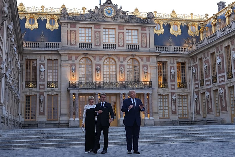 Trump greeted by French President Emmanuel Macron and and first lady Brigitte Macron as he arrives at the Palace of Versailles, Wednesday, June 17, 2026, in Versailles, France