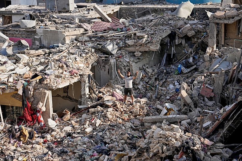 A man flashes victory sign as he stands on the rubble of his destroyed house in Nabatiyeh town, southern Lebanon, Tuesday, June 16, 2026.