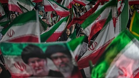 FILE: Pro-regime demonstrators wave Iranian flags and a portrait of Ayatollah Mojtaba Khamenei and his slain father in a gathering at a square in Tehran, 29 May 2026