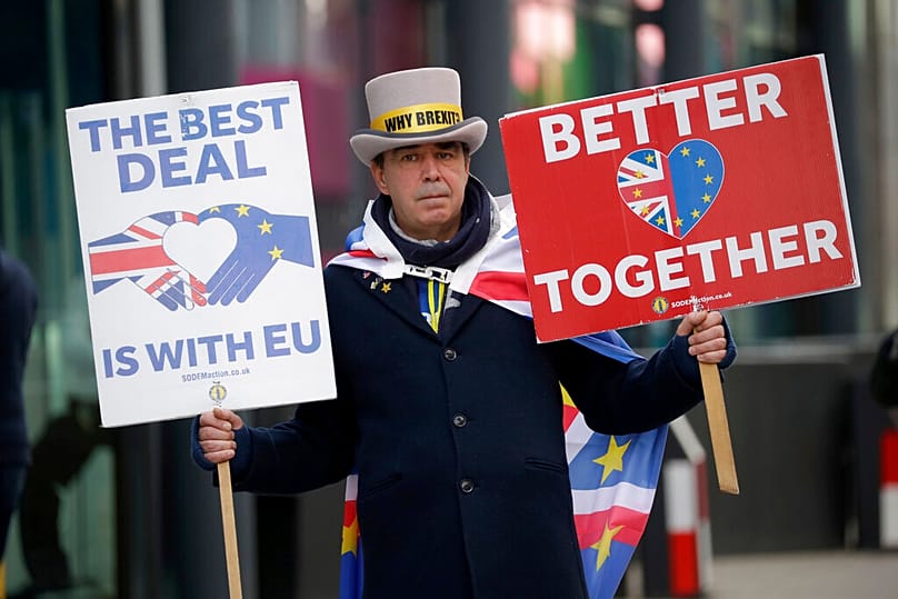 FILE: Anti-Brexit protester Steve Bray holds placards outside the Conference Centre in London, 9 November 2020