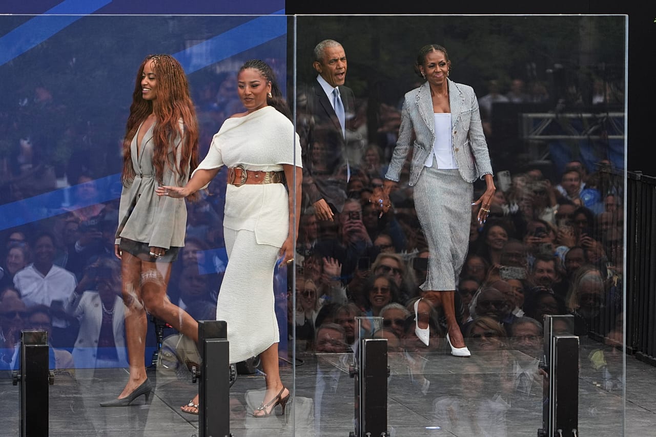 Barrack and Michelle Obama taking to the stage with their two daughters, Malia and Sasha. 