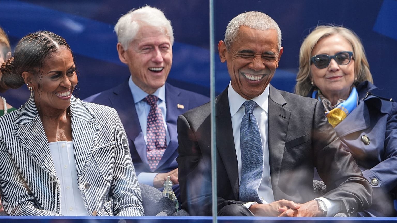 Former President Barack Obama, right, shares a laugh with former first lady Michelle Obama. 