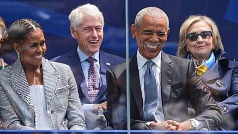 Former President Barack Obama, right, shares a laugh with former first lady Michelle Obama. 