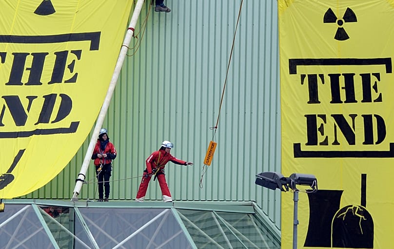 Greenpeace activists hang banners saying "The End" at a building of the Beznau nuclear power plant, 5 March, 2014 