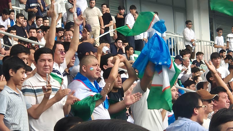Uzbek fans celebrating, while watching the game in Bunyodkor Stadium in Tashkent