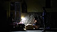 Street vendors chat during a blackout in Havana, 16 March, 2026