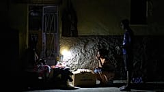 Street vendors chat during a blackout in Havana, 16 March, 2026