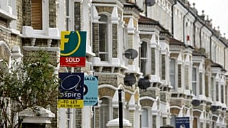 Estate agents' boards are seen in south London, Tuesday Feb. 17, 2009. 