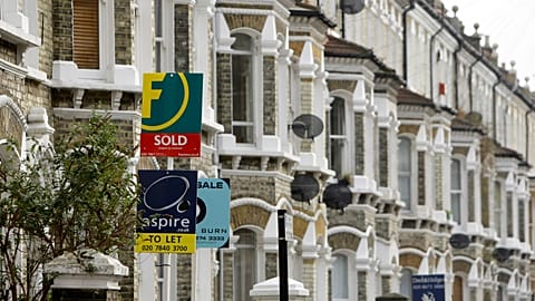 Estate agents' boards are seen in south London, Tuesday Feb. 17, 2009. 