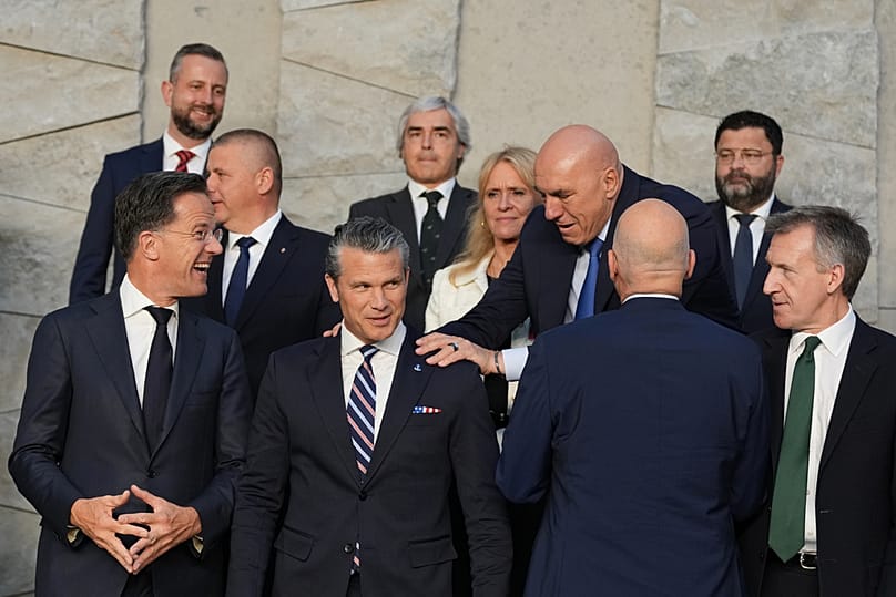 Italy's Defense Minister Guido Crosetto greets Pete Hegseth during a group photo of NATO defence ministers at NATO headquarters in Brussels, Thursday, June 18, 2026