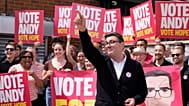 Labour candidate Andy Burnham gestures, surrounded by supporters at the Stubshaw Cross Community and Sports Club as voting is underway in the Makerfield by-election.