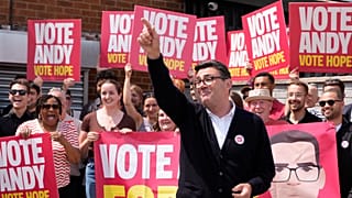 Labour candidate Andy Burnham gestures, surrounded by supporters at the Stubshaw Cross Community and Sports Club as voting is underway in the Makerfield by-election.
